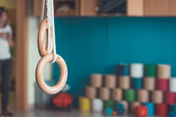 Physical education concept: Gym rings in gym hall of Kindergarten