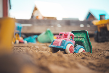 Childhood sandbox concept: Close up of plastic toy truck