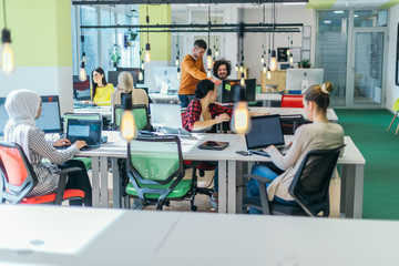 Successful team. Group of young business people working and communicating together in creative office