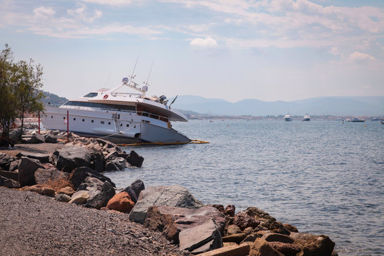 Crashed yacht on the coast of Mediterranean Sea. Horizontal shot