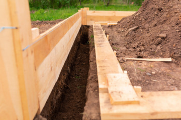 Fototapeta na wymiar Wooden formwork for new house strip foundation