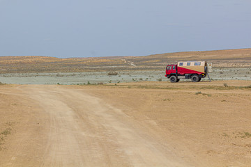 Tourist truck near Darvaza (Derweze) gas crater (Door to Hell or Gates of Hell) in Turkmenistan