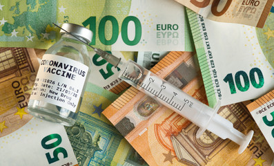Coronavirus Covid-19 vaccine price / cost concept - glass vial with silver cap on pile of euro bank...