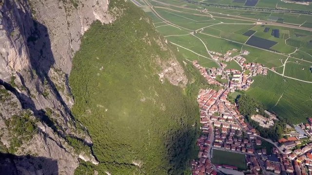Bird's Eye view of Mezzocorona -- A small Quaint village in Trentino, Northern italy. Camera Tilts up to massive alps mountains