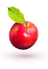 Red apple with green leaves fly on a white background.