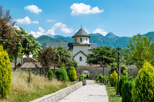 Monastery on the river Moraca amid mountains in the background.