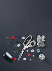 sewing items on a black background from above