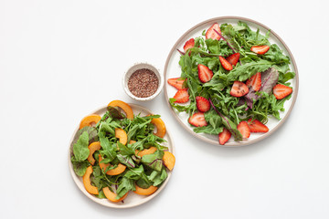 Delicious healthy salad of fresh strawberries ,loquat and arugula