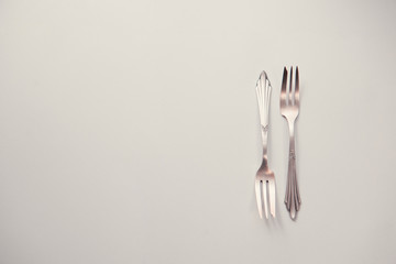 Old cutlery, lying on a wooden table. Texture, background