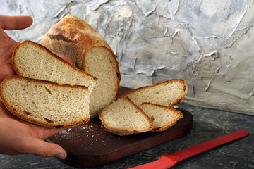 freshly baked sliced ​​bread in the hands of a baker