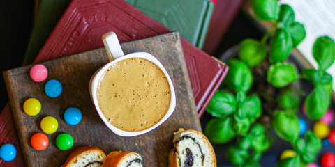 cup of coffee and bun dessert, reading books Menu concept. food background top view copy space