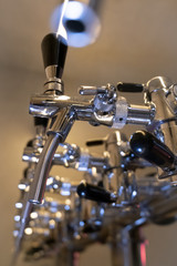 Beercraft steel silver taps raw in pub, different focus. Close up of beer tap. Beer equipment.