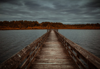 Fototapeta na wymiar Wooden pier on a lake with a cloudy sky. 