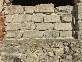 Old wall of red brick and natural stone
