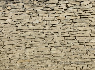Old wall made of yellow mountain flat stone