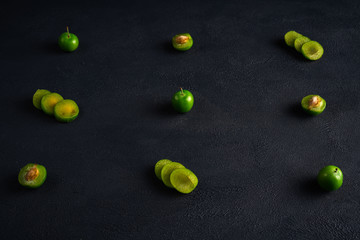 Green sour plum. Greengage on dark background.  Top view. Copy space for text message.
