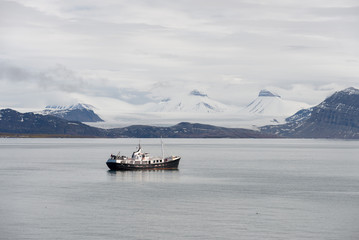 Small sailing vessel with beautiful lighting in Svalbard