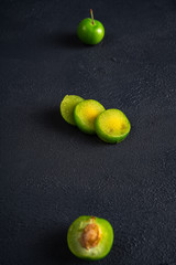 Green sour plum. Greengage on dark background.  Top view. Copy space for text message.