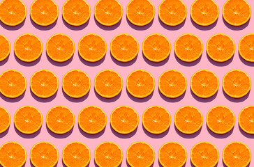 Pattern of orange slices against pink background