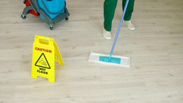 Janitor mopping floor in office