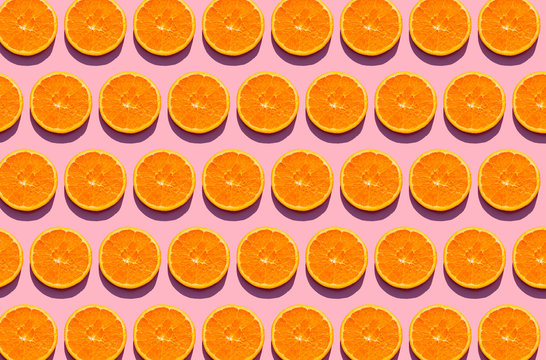 Pattern of orange slices against pink background