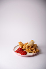 Obraz na płótnie Canvas pancakes with strawberry sauce on a plate