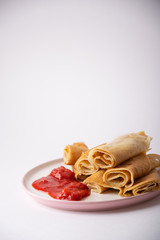 pancakes with strawberry sauce on a plate