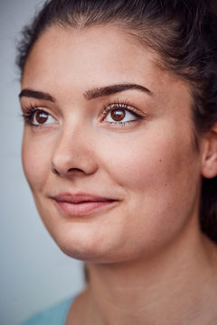 Portrait of smiling young woman with brown eyes