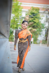 Fototapeta na wymiar Portrait smiling Asia Girl in Thai Traditional Antique Dress of Old Kingdom in Siam, Southeast Asia.