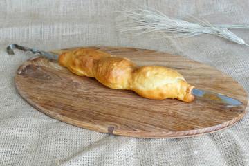 Asian skewers of samsa puff pastry on a skewer on a round kitchen board on a background of burlap