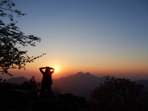 Silhouette of woman watching  sunset, Serra da Leba, Angola