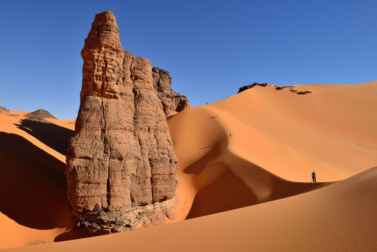 Algeria, Tassili n' Ajjer, Tadrart, Sahara, Tassili n' Ajjer National Park, view to sand dunes and rocks of Moul Nag with people at background