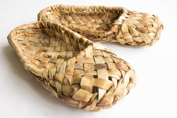 Bast shoes-traditional Russian peasant shoes close-up isolated on white background