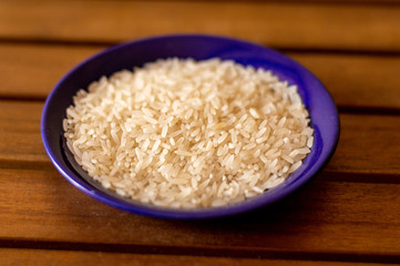 raw rice in a blue bowl