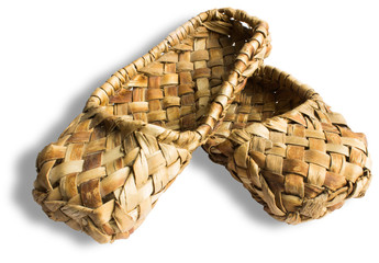Bast shoes-traditional Russian peasant shoes close-up isolated on white background