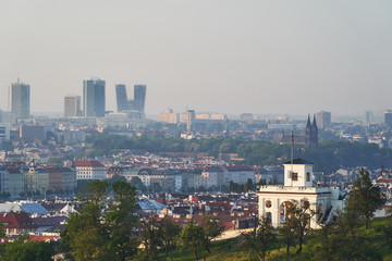 Fototapeta na wymiar Panoramatic cityscape of Prague, capitol of Czech republic, taken in sunny spring morning after sunset and shown mix of traditional architecture along the Vltava river and modern buildings at horizon.
