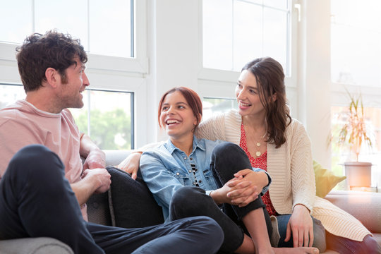 Happy Family Sitting On The Couch At Home