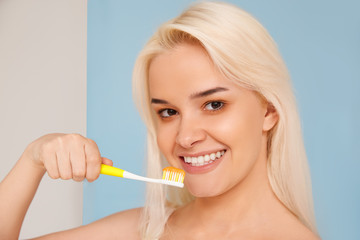 Woman with beautiful smile, healthy white teeth with toothbrush. High resolution image