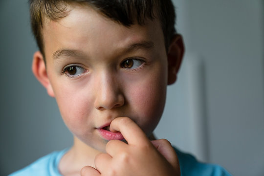 Portrait of little boy with finger in mouth