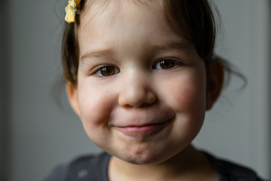 Portrait of smiling little girl with brown eyes
