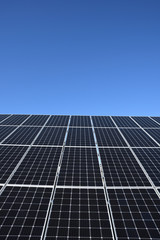 Solar panels against blue sky background.Against The Deep Blue Sky in suny weather