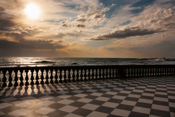 Sunset from Mascagni terrace in Livorno with stormy sea - obrazy, fototapety, plakaty