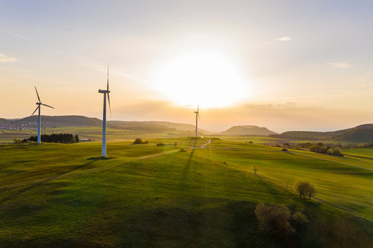 Germany, Baden-Wurttemberg, Burladingen, Aerial view of countryside wind farm at sunset