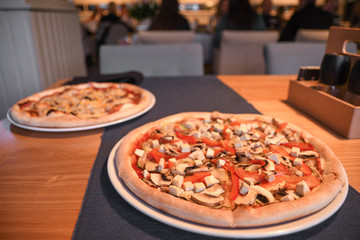 Vegetarian pizza on the table in cafe. Close-up