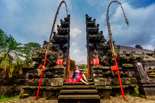 Woman posing for photo at the Besakih Temple, the largest and holiest temple of Hindu religion in Bali, Indonesia, Southeast Asia, Asia