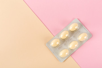 Tablets in strip over pink background, vaginal antibacterial capsules
