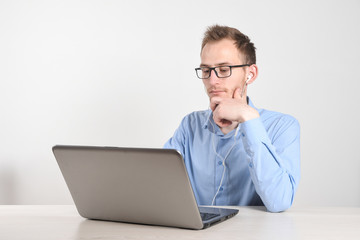 Man using laptop at home in living room. Mature businessman send email and working at home.Work at home. Typing on computer with paperworks and documents on table.