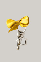 House key with red bow on white background