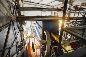 Modern industrial boiler room with biomass boilers installed in. Top view with pipes, pipelines,...