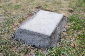 concrete block embeded on a ground